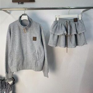Miu Miu grey zipper hooded coat and cake skirt set